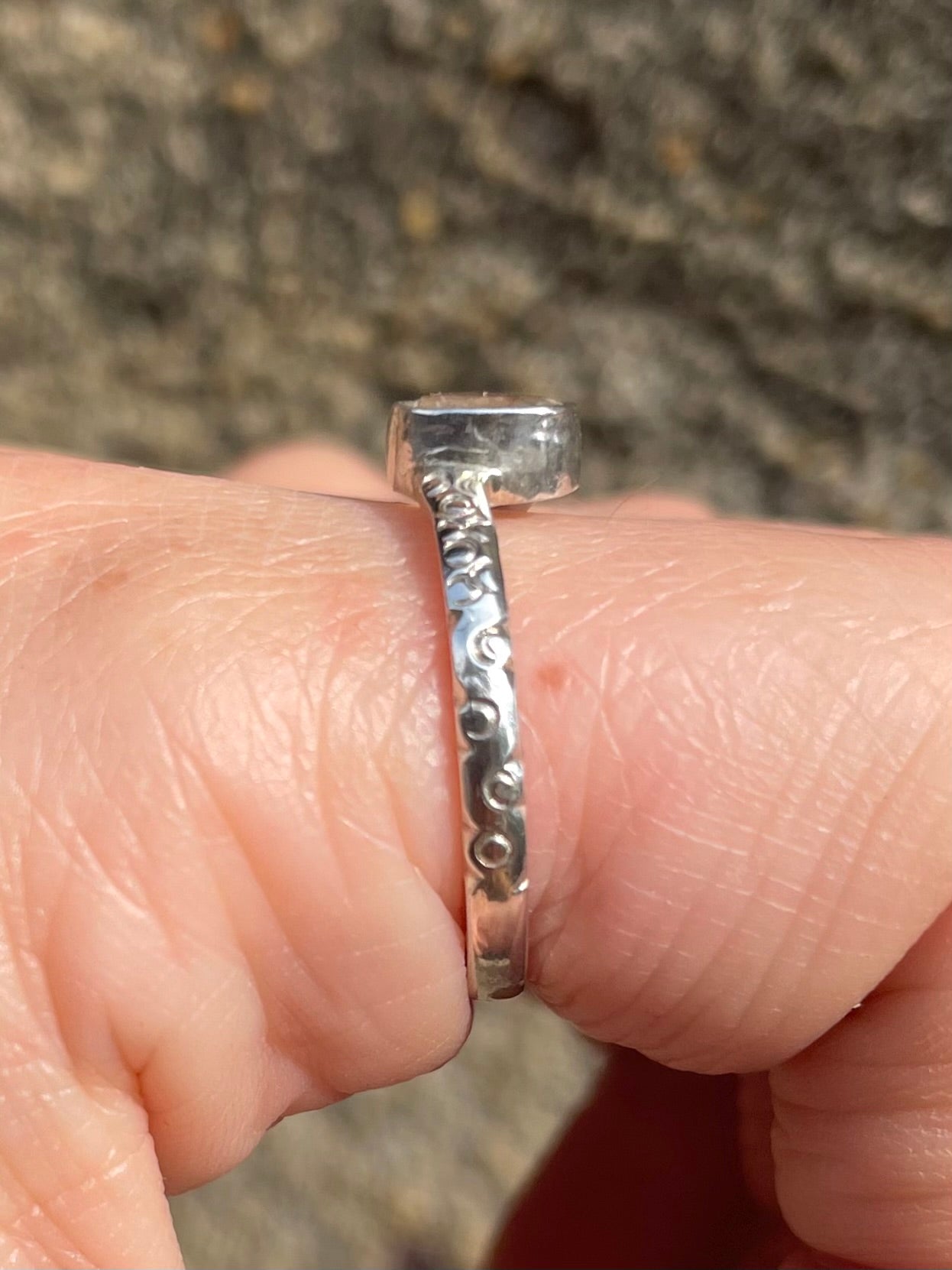 Profile of White Sapphire and silver ring on hand in Sri Lanka size 7