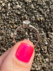 Hand holding white sapphire and silver ring hand crafted in Sri Lanka size 7
