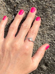 Full view of hand with nail polish and Sri Lankan sapphire and silver ring 