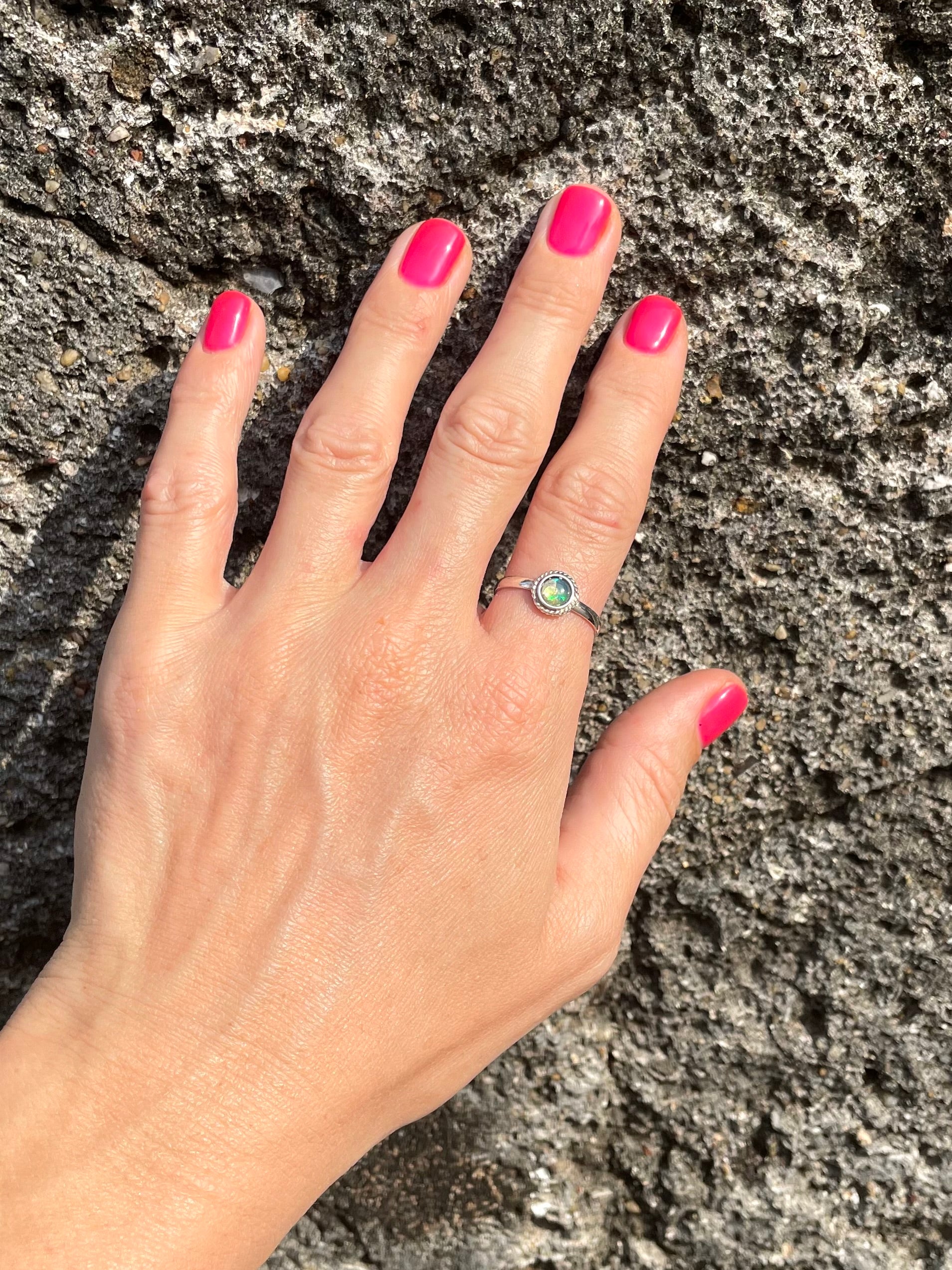 Hand showing a Sri Lankan genuine opal and silver ring made by local artisan