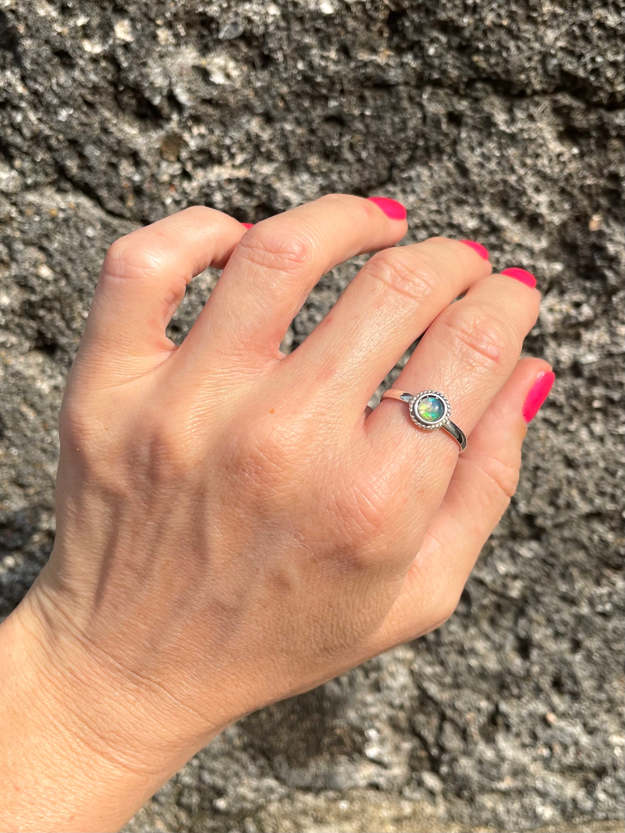 Lovely photo of Sri Lankan Halo opal ring with detailed silver